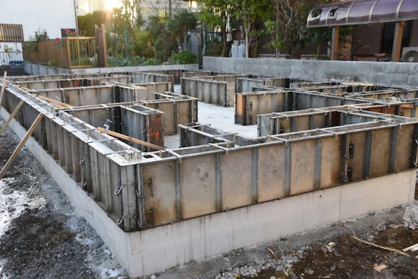 Metal formwork panels assembled in a residential lot to prepare for a concrete foundation pour in Fullerton.